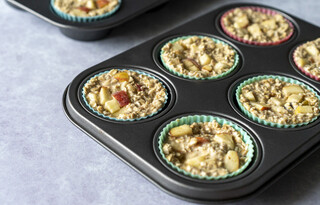 <p>Divide the mixture into 12 muffin cases and top each with remaining diced apples.<br />Pop in the oven for 30-35 minutes or until the middle of the muffin has set and a toothpick comes out clean.</p>
